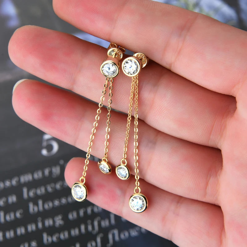 Moissanite Chain Tassel Earrings in Sterling Silver — Gold-tone bezel drops on hand