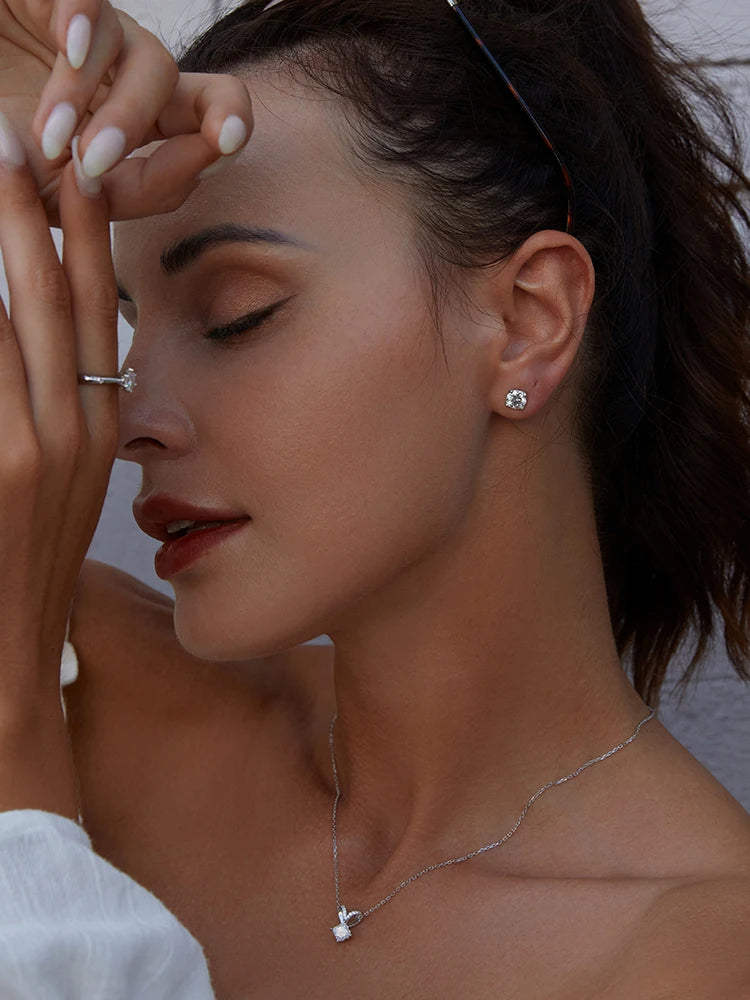 Four-Prong Moissanite Solitaire Stud Earrings in Silver - Solitaire styling on model