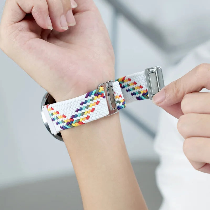 White rainbow braided strap being adjusted on wrist