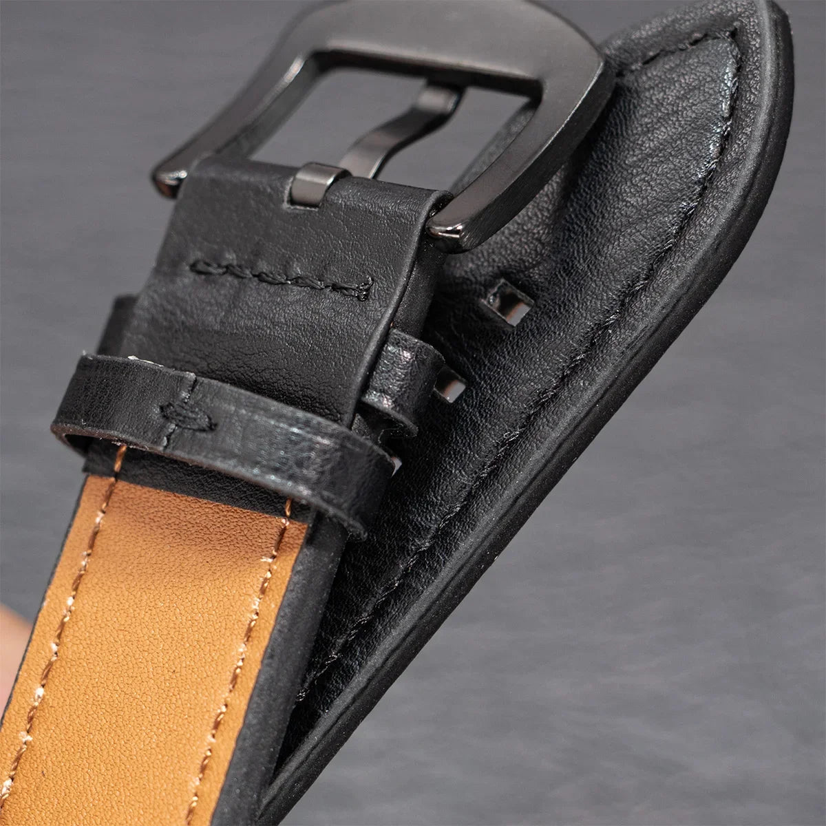 Black leather strap buckle and tan underside