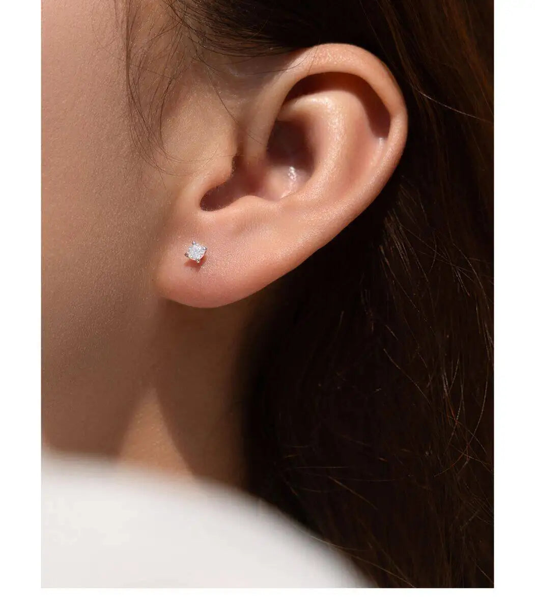 Four-Prong Moissanite Solitaire Stud Earrings in Silver — Stud worn on ear