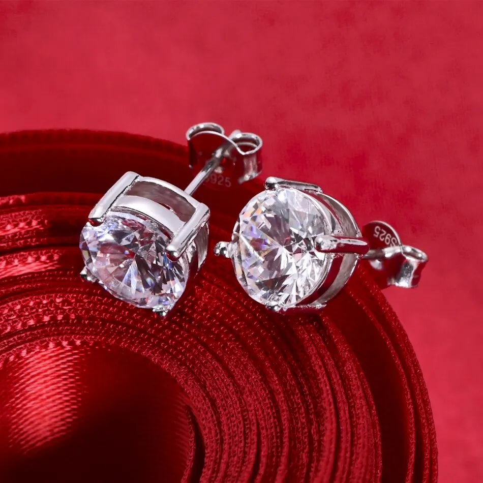 Round Four-Prong Moissanite Stud Earrings in Sterling Silver — Angled pair