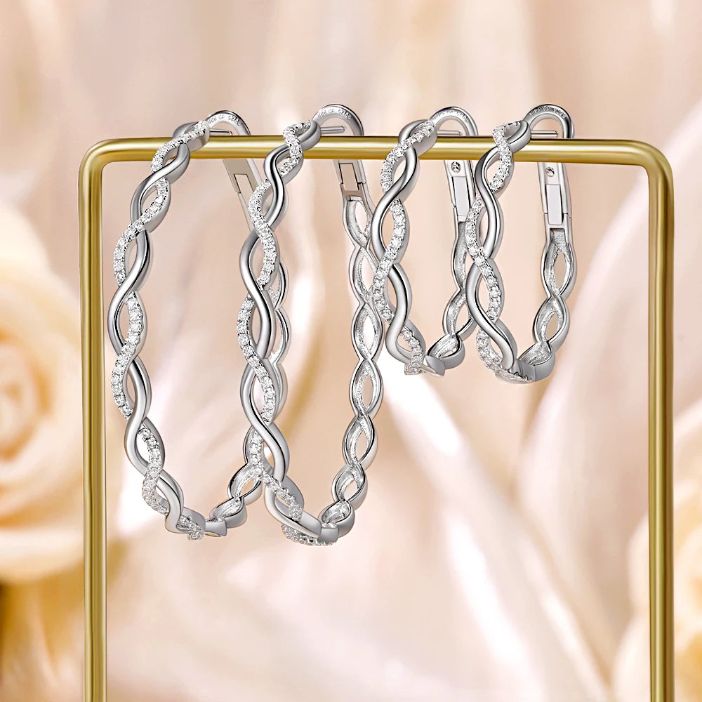 Twisted Infinity Moissanite Hoop Earrings in Sterling Silver — Large and small hoops displayed together