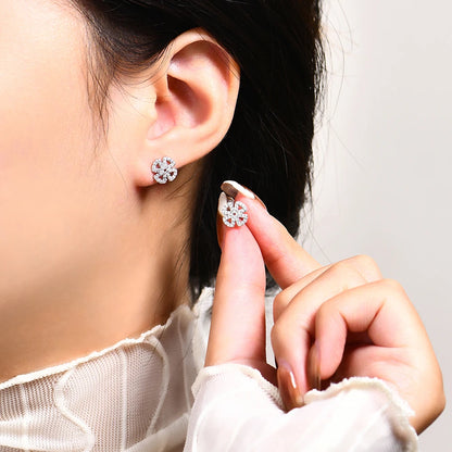 Open Flower Moissanite Stud Earrings in Sterling Silver — Silver flower studs worn on the ear