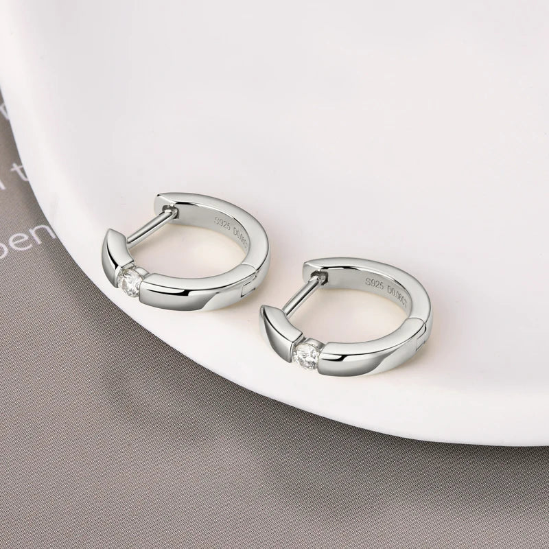 Minimalist Moissanite Hoop Earrings in Sterling Silver — Silver pair laid flat