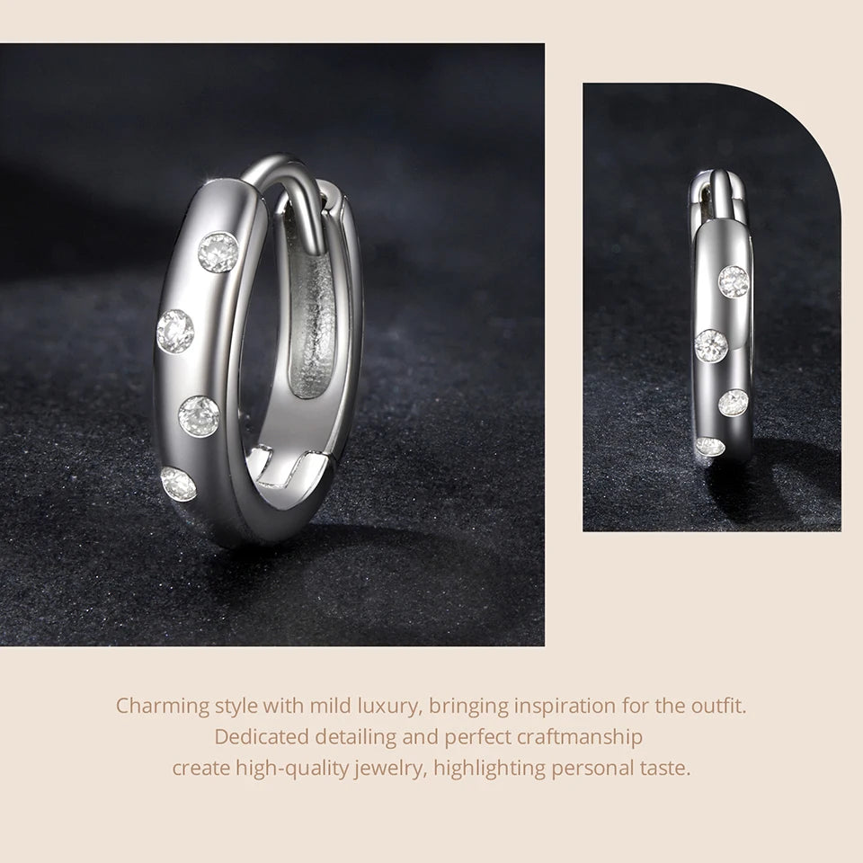 Scattered Moissanite Huggie Earrings in Sterling Silver — Polished silver-tone hoop detail