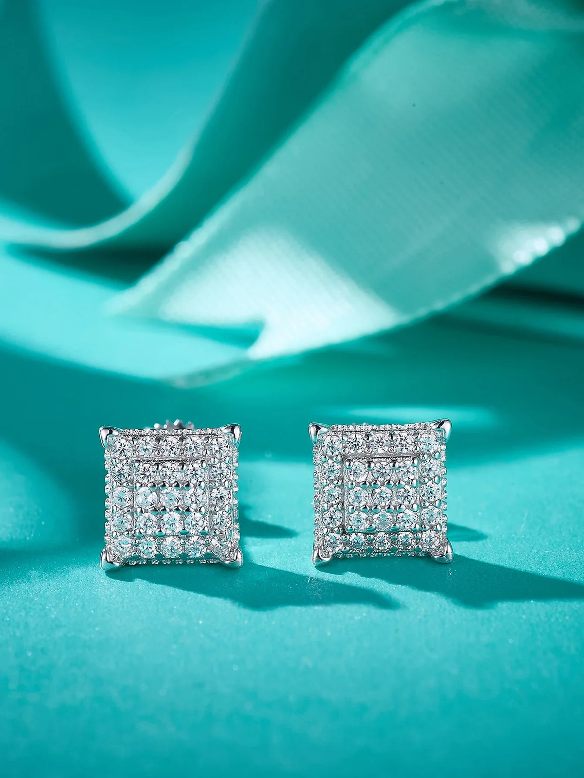 Square Pavé Moissanite Stud Earrings in Sterling Silver - Square fronts on green background