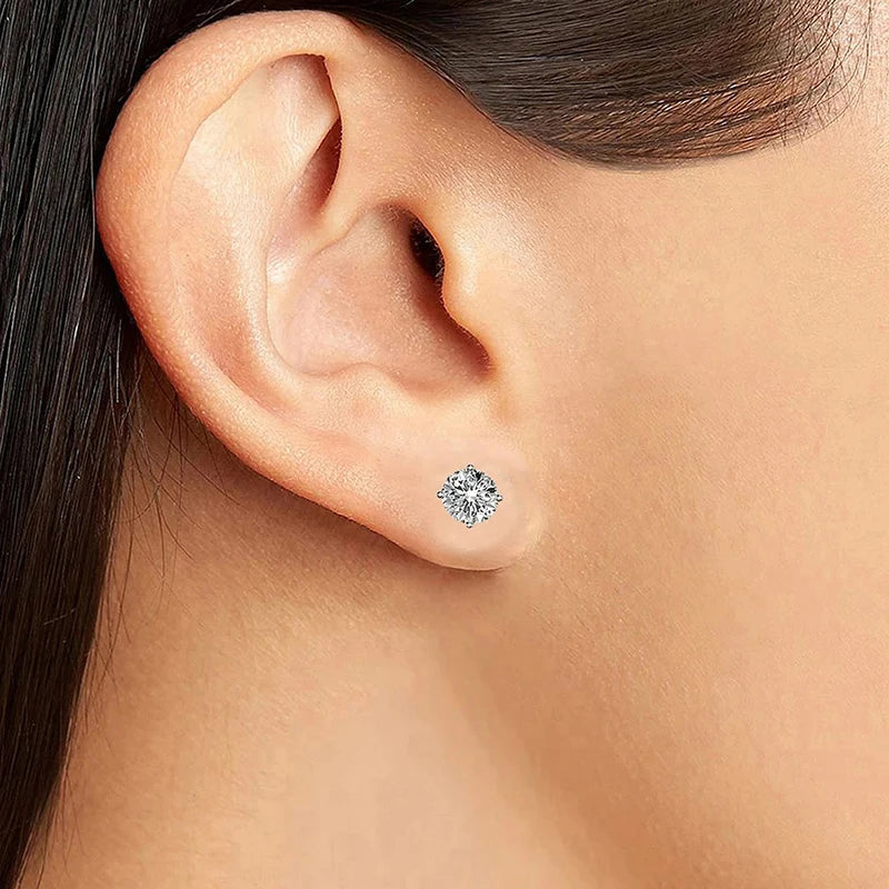 Four-Prong Round Moissanite Stud Earrings in Silver — Stud worn on ear