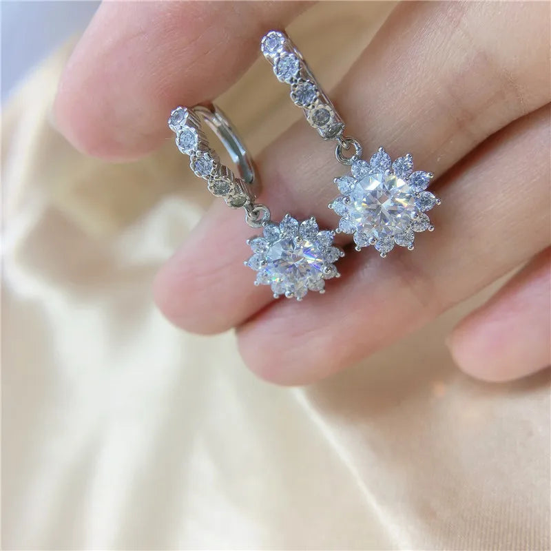 Sunflower Moissanite Drop Hoop Earrings in Sterling Silver - Earrings shown on hand