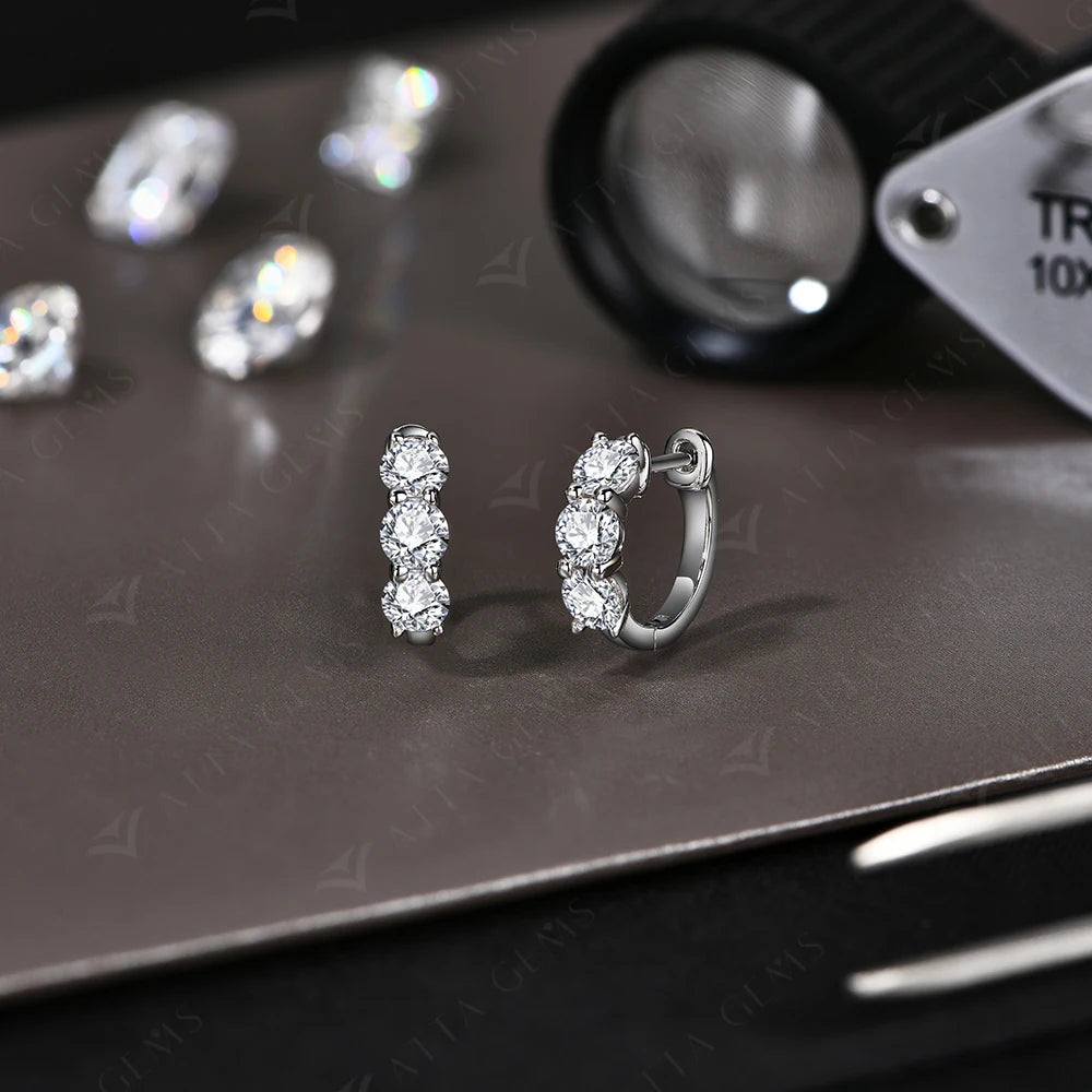Three-Stone Moissanite Hoop Earrings in Sterling Silver — Silver pair on display