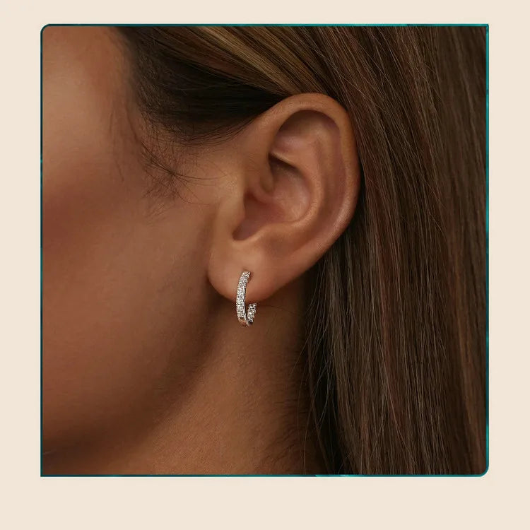Inside-Out Moissanite Huggie Hoop Earrings in Sterling Silver — Silver huggie worn on the ear