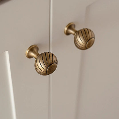 Ribbed solid brass ball cabinet knob in antique brass