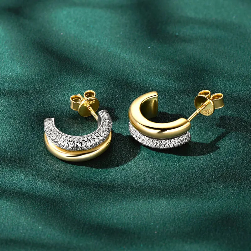 Double-Row C-Shaped Moissanite Stud Earrings - Gold-tone pair on green background