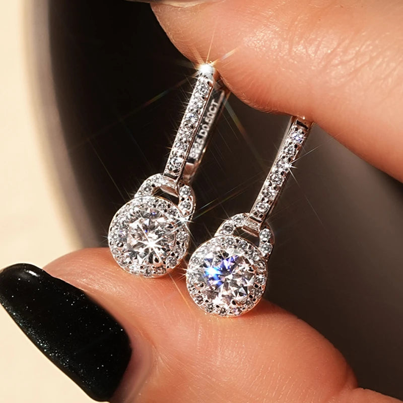 Lock-Style Halo Moissanite Drop Earrings in Sterling Silver - Lock-style halo drops shown on hand