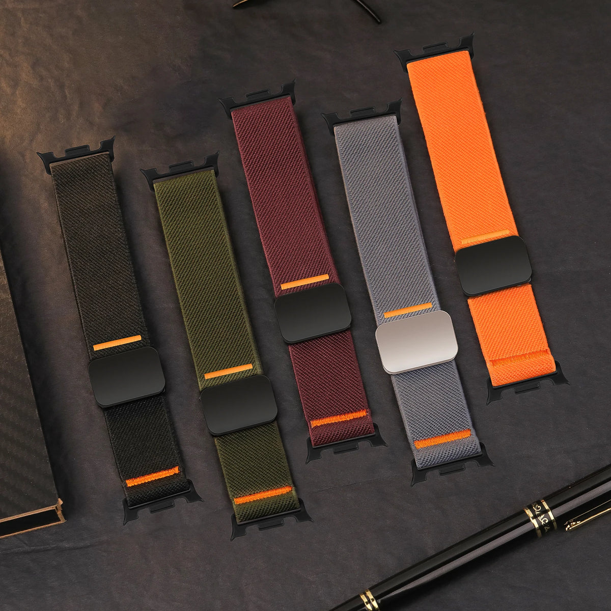 Nylon bands with orange accents laid flat