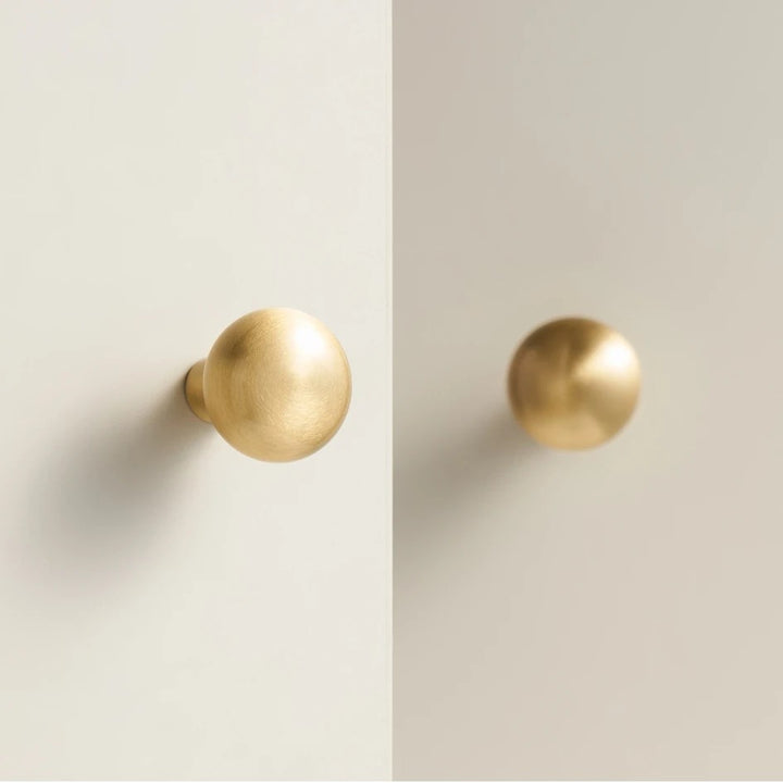 Smooth solid brass round cabinet knob in brushed brass