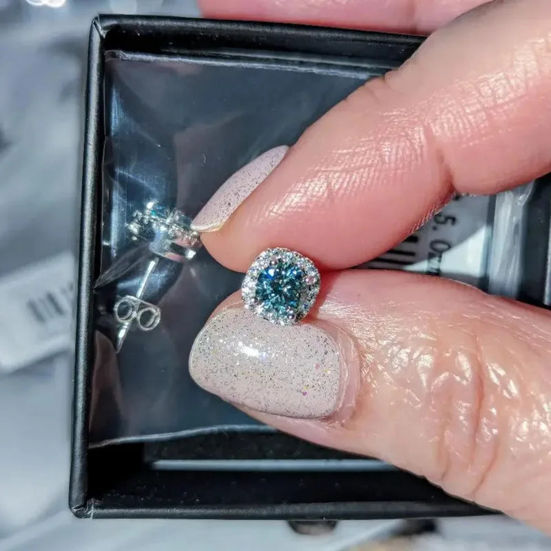 Colored Cushion Halo Moissanite Stud Earrings in Silver - Blue halo stud on hand