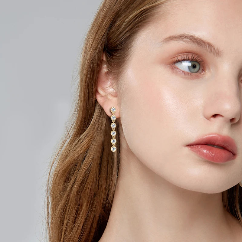 Six-Stone Moissanite Line Drop Earrings in Sterling Silver — Line drops worn on the ear