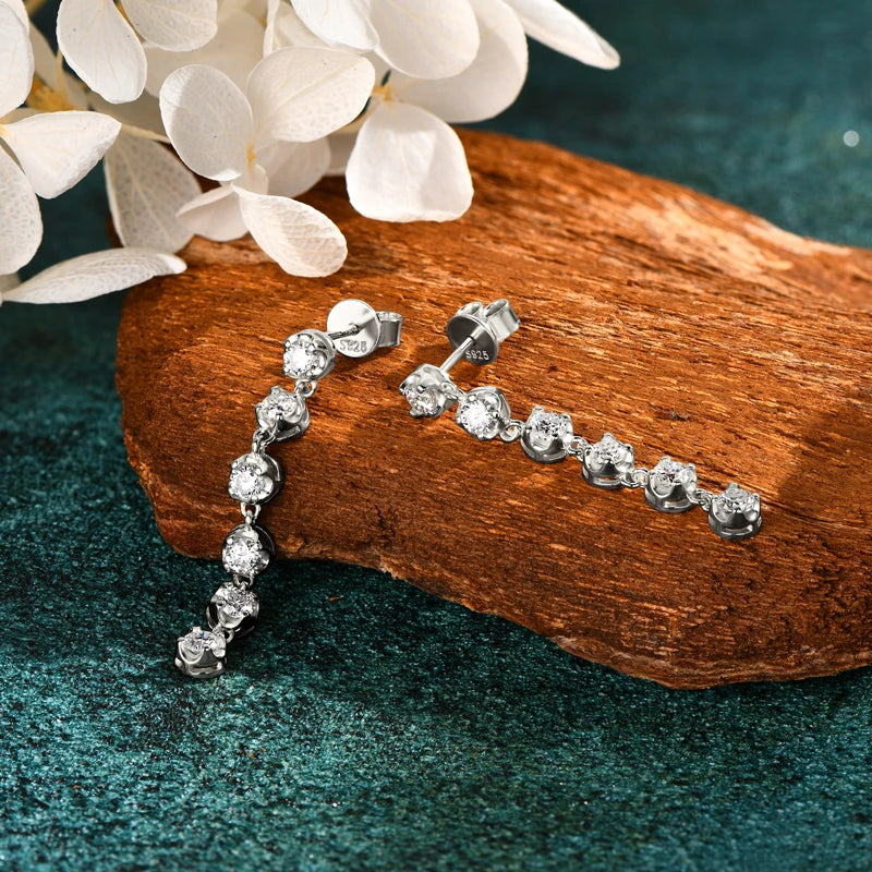 Six-Stone Moissanite Line Drop Earrings in Sterling Silver — Silver pair laid flat